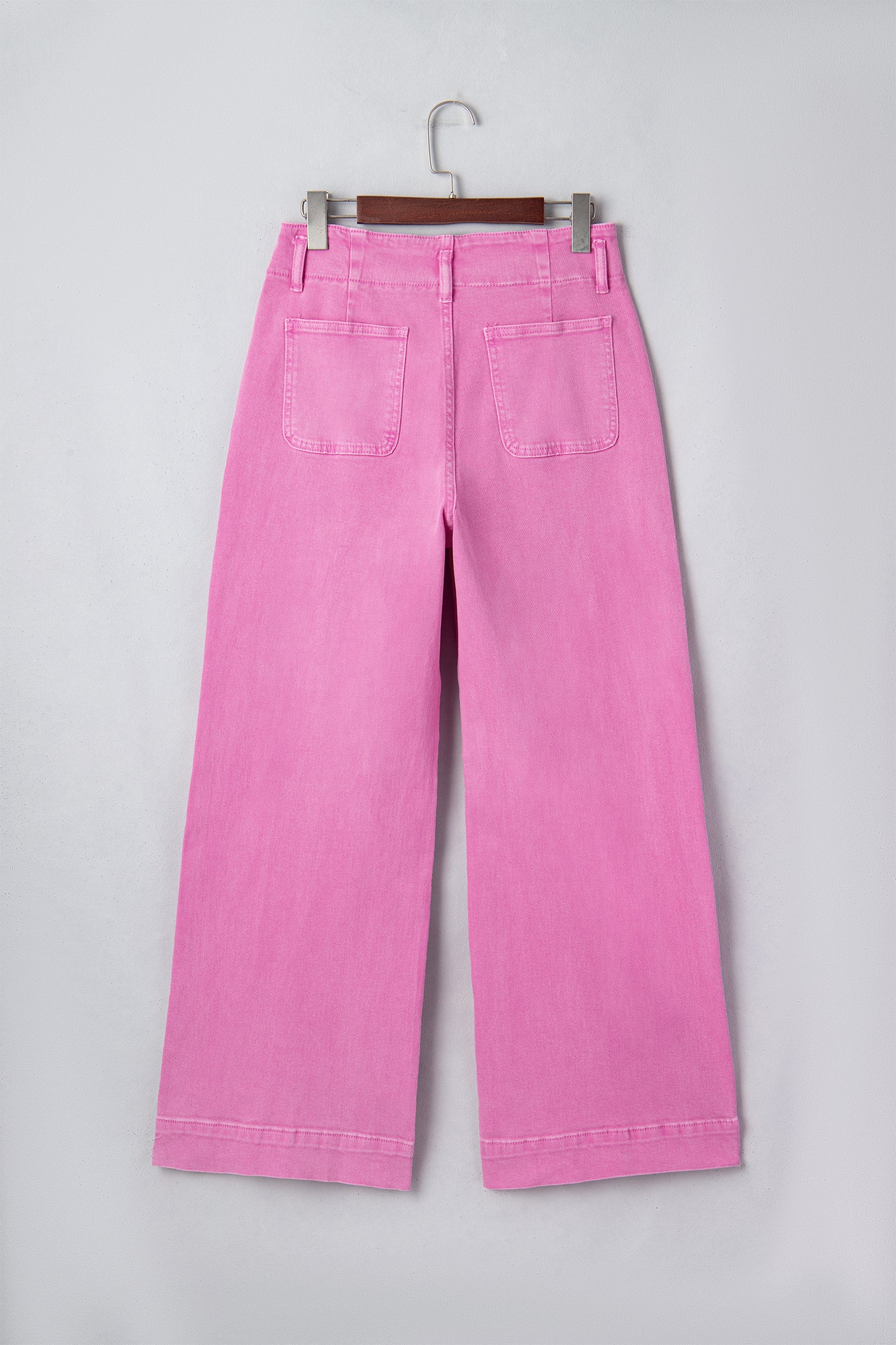 Pink high rise wide leg jeans with double-button waistband, front pockets and cropped hem.