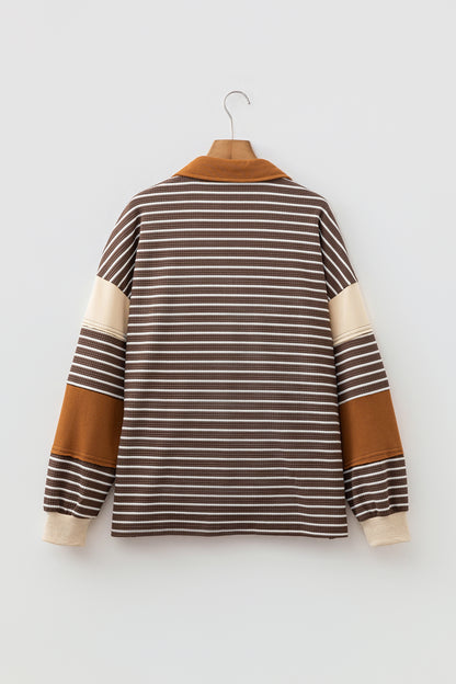 Cocoa Caramel and ivory striped colorblock pullover with a collared V-neckline, dropped shoulders, and long paneled sleeves.