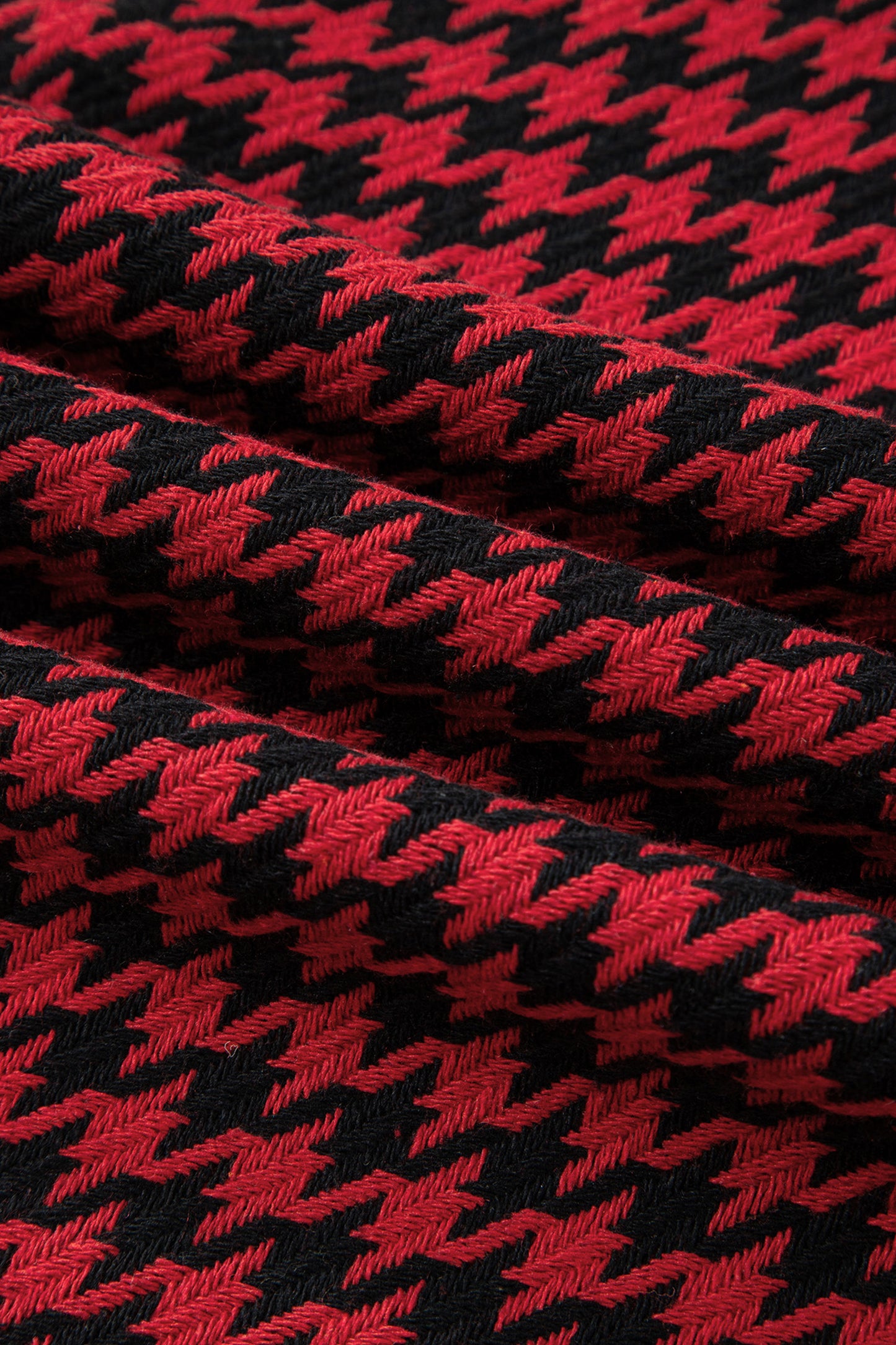 Red textured houndstooth jacquard sleeveless mini dress with V-neckline and A-line silhouette.