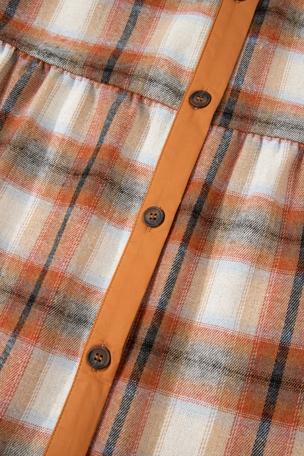 Caramel plaid tunic shirt dress with collared neckline, button front, chest pockets, long sleeves, and relaxed mini silhouette.