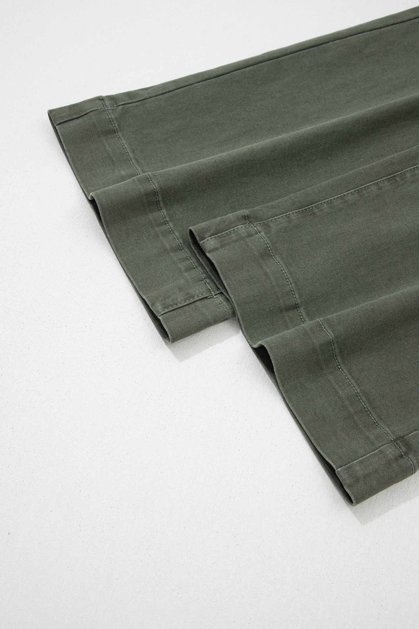 Olive green high rise wide leg jeans with double-button waistband, front pockets and cropped hem.