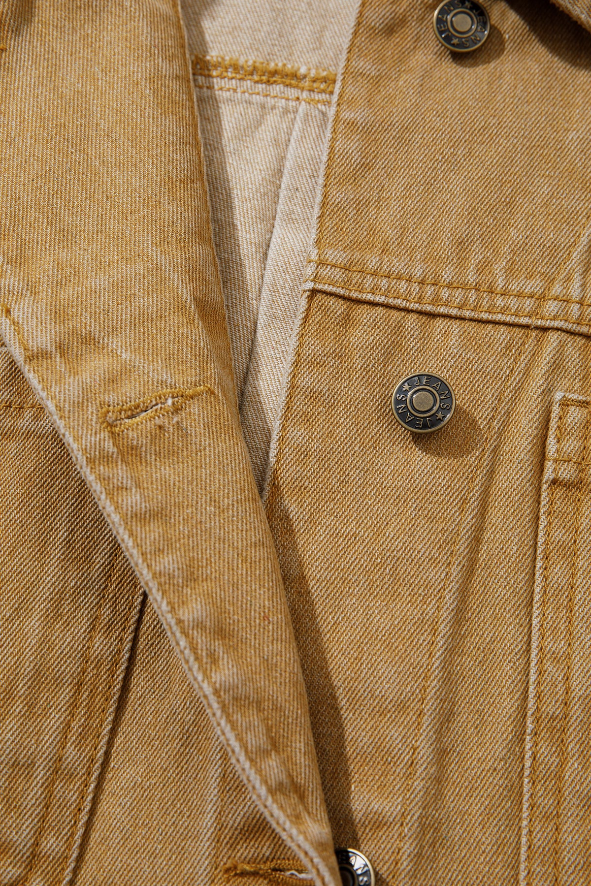Tan women's denim jacket with metal button front, collared neckline, long sleeves, patch pockets, and relaxed fit.