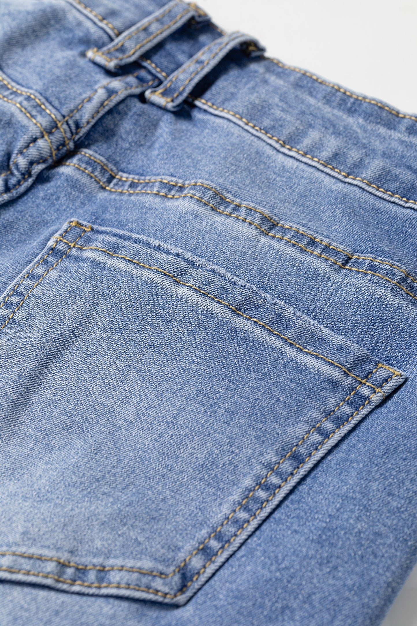 Light Wash Blue high rise Western flare jeans with embroidered lower-leg detailing and full-length wide leg silhouette.
