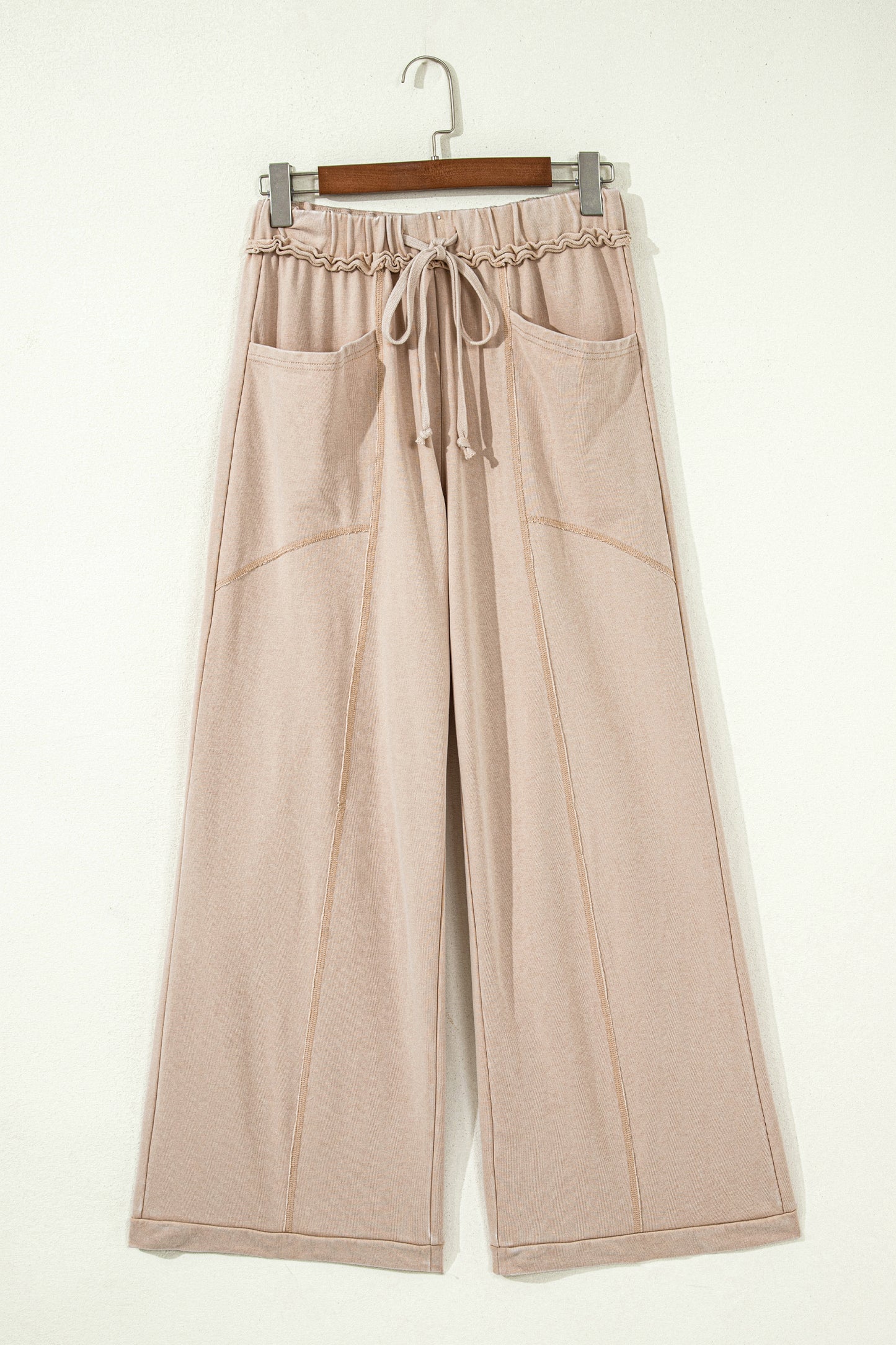 Sand washed cotton wide leg pants with drawstring waist, oversized patch pockets, and relaxed fit.
