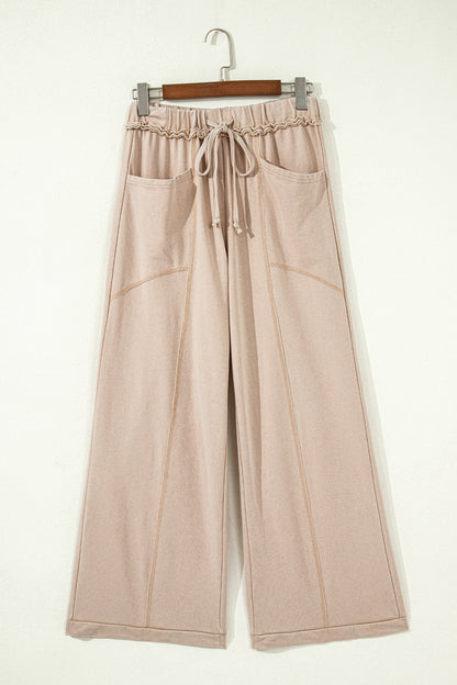 Sand washed cotton wide leg pants with drawstring waist, oversized patch pockets, and relaxed fit.