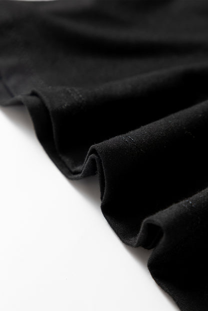 Woman wearing a Classic Black scoop neck long sleeve top with a soft casual fit and white pants.