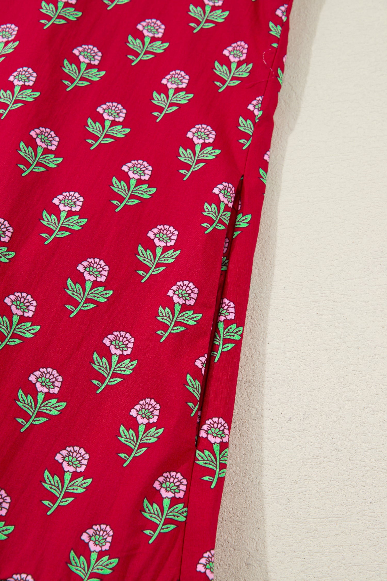 Red floral mini dress with pink collared neckline, mint scalloped trim, short puff sleeves, and a ruffled drop-waist hem
