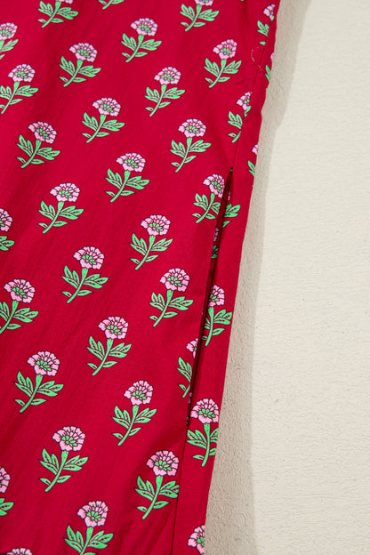 Red floral mini dress with pink collared neckline, mint scalloped trim, short puff sleeves, and a ruffled drop-waist hem