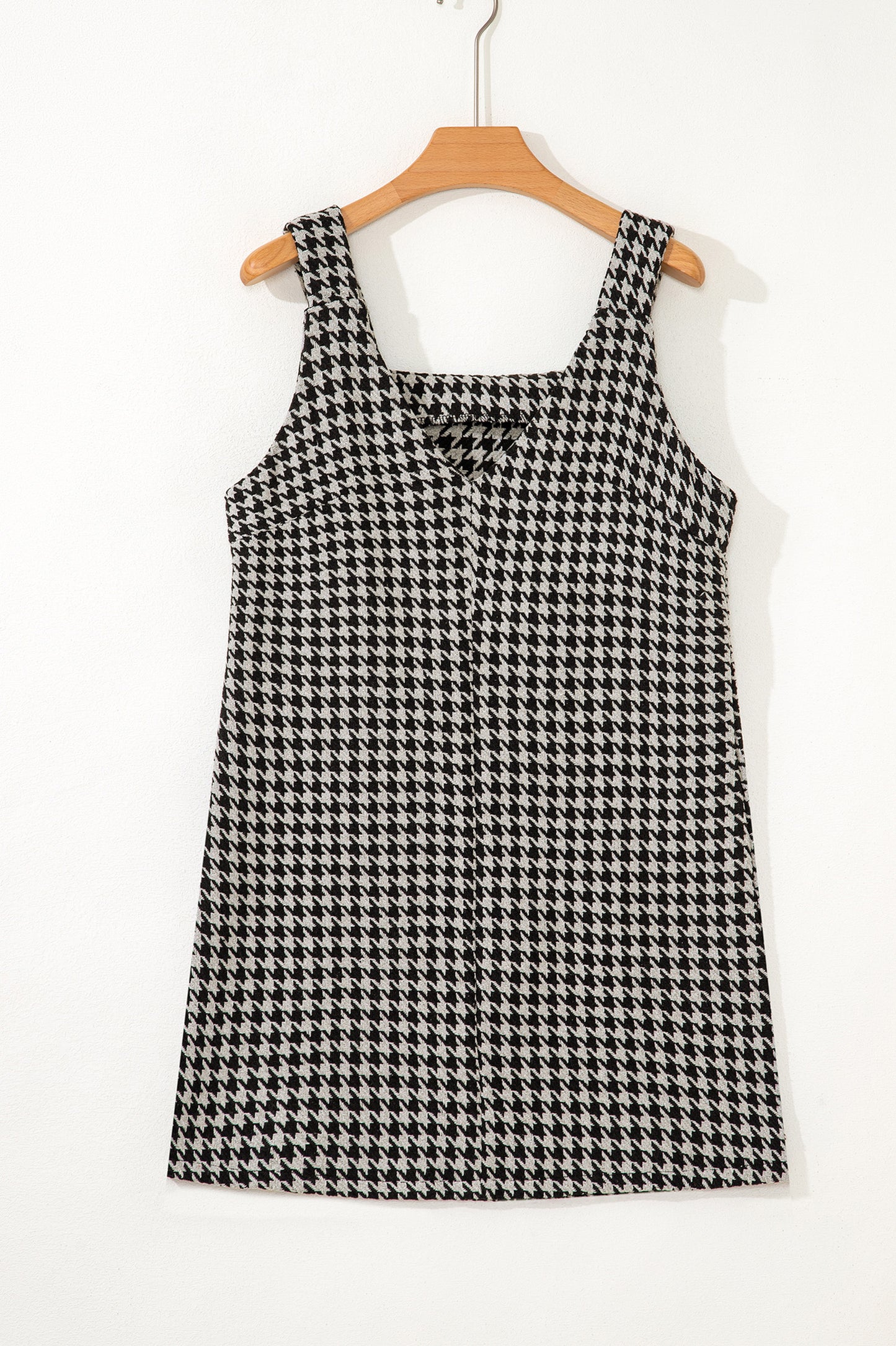 Black textured houndstooth jacquard sleeveless mini dress with V-neckline and A-line silhouette.