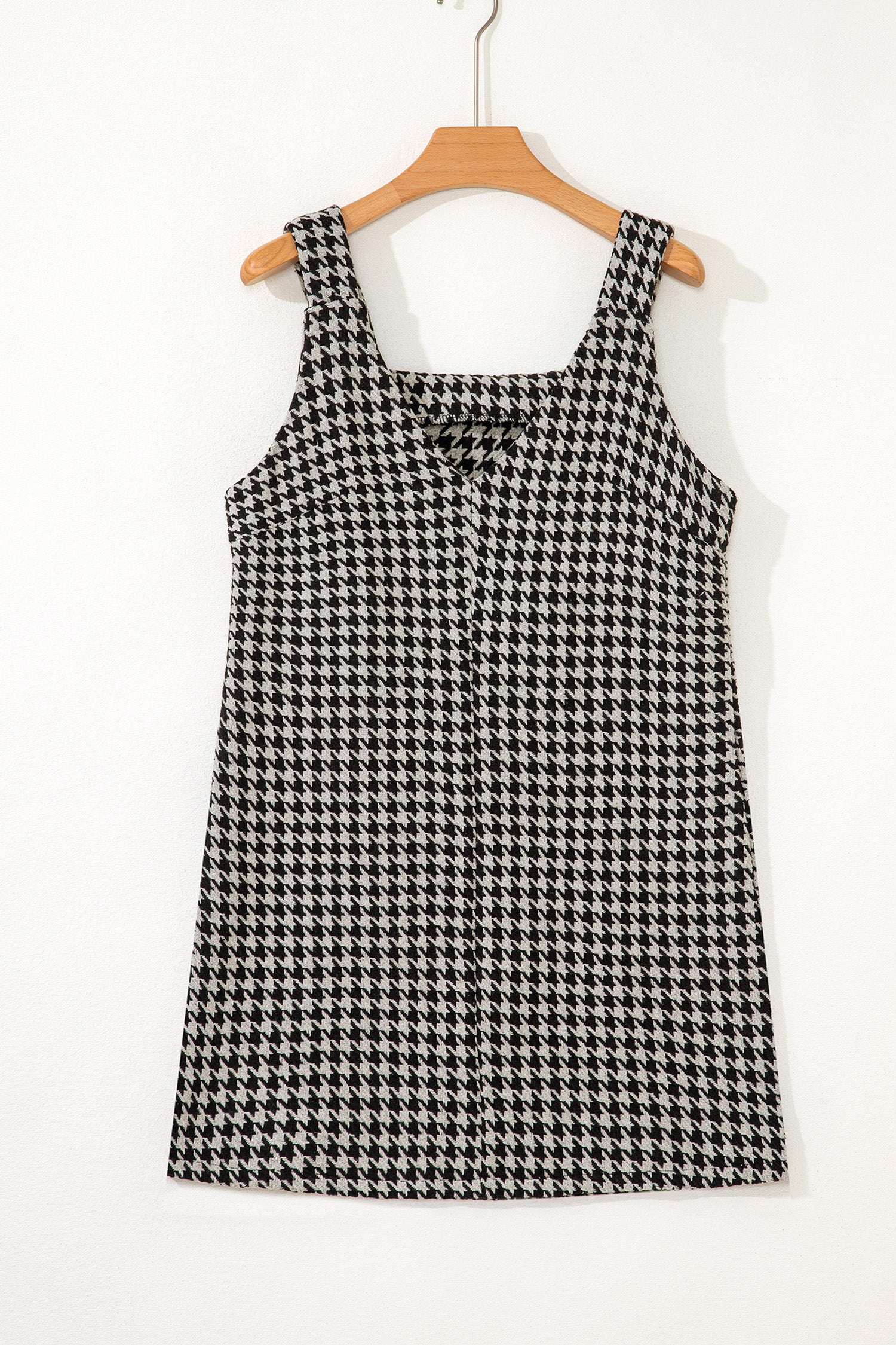 Black textured houndstooth jacquard sleeveless mini dress with V-neckline and A-line silhouette.