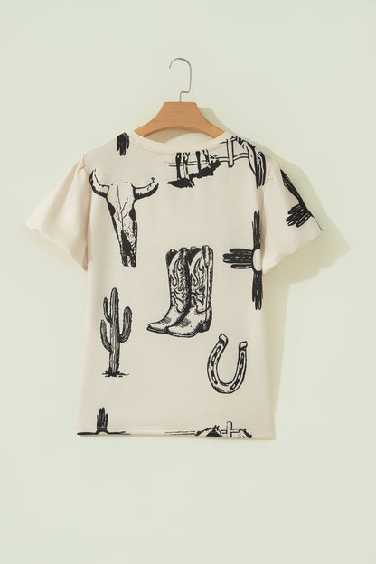 Cream Western graphic print top with crew neckline, short sleeves with gathered armholes, and black cowboy boot, cactus, horseshoe, and Southwestern motifs.