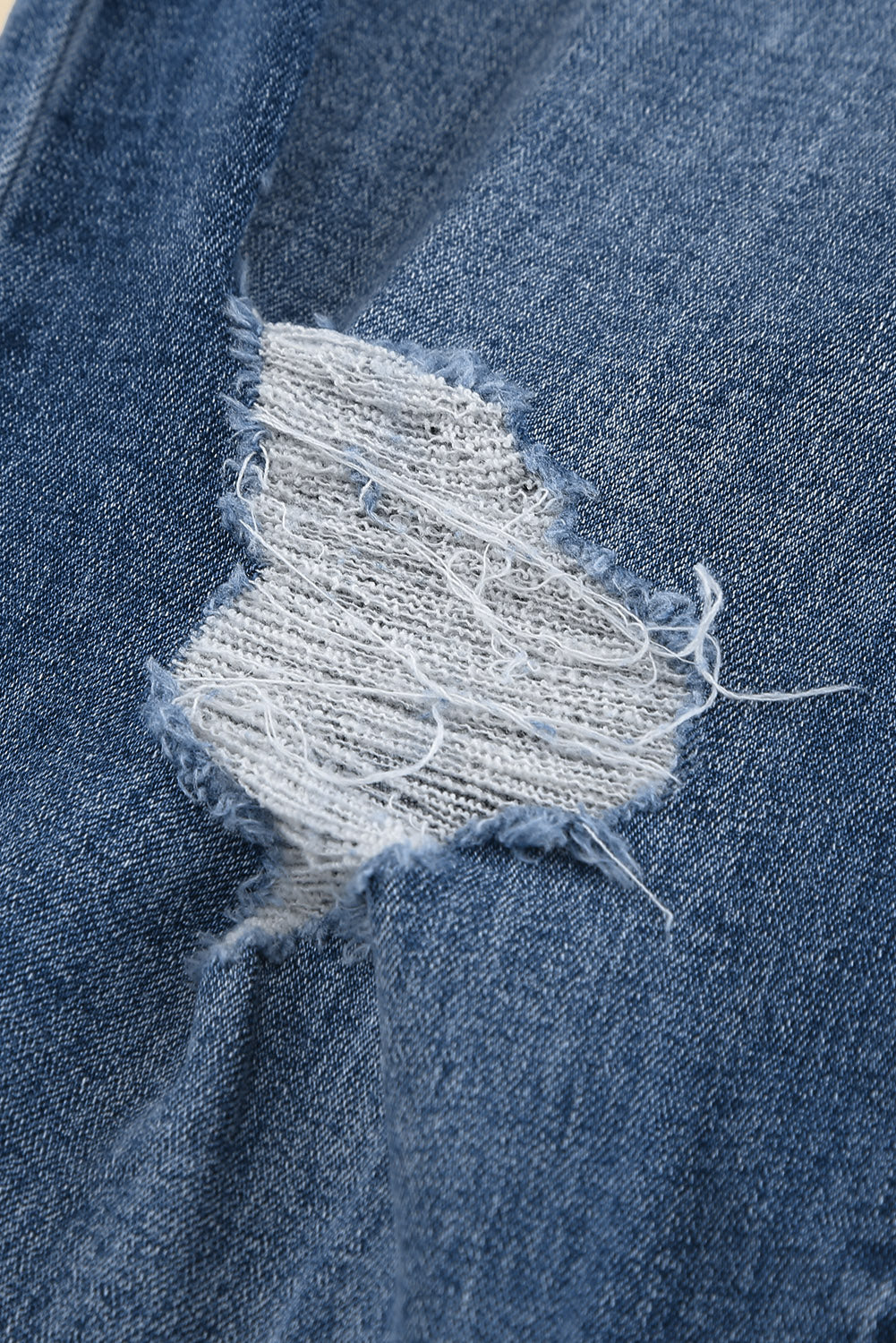 Medium wash blue distressed slim straight leg jeans with drawstring elastic waist and raw hem