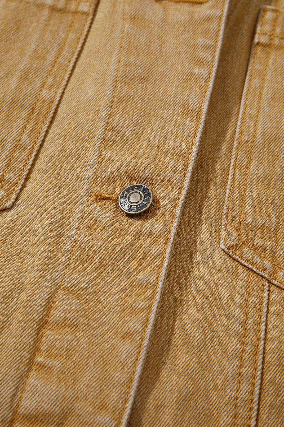 Tan women's denim jacket with metal button front, collared neckline, long sleeves, patch pockets, and relaxed fit.