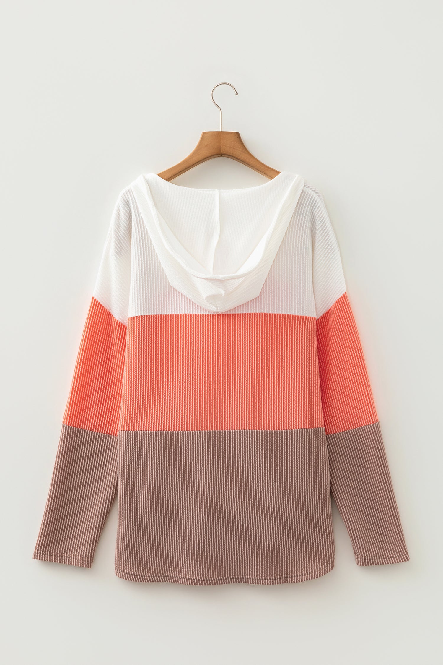 Women's ribbed color block hooded top in ivory, coral, and taupe with a V-neckline, drawstrings, long sleeves, and relaxed fit.