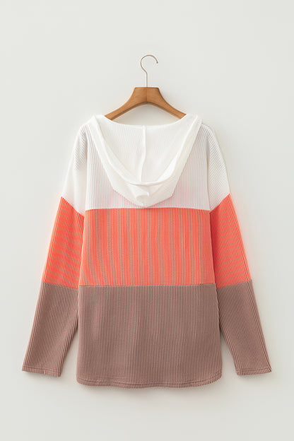 Women's ribbed color block hooded top in ivory, coral, and taupe with a V-neckline, drawstrings, long sleeves, and relaxed fit.