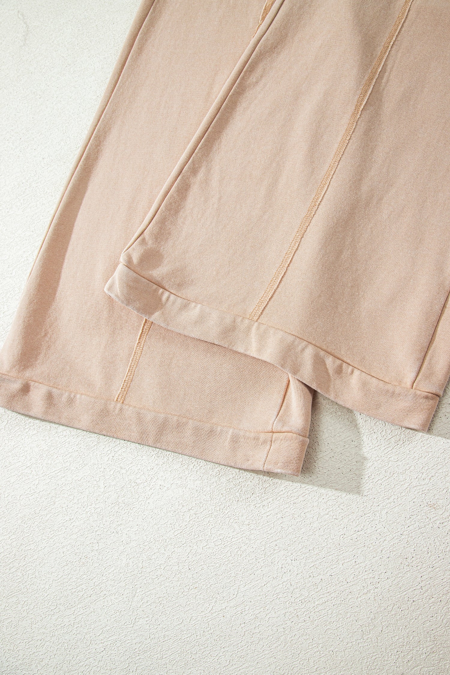 Sand washed cotton wide leg pants with drawstring waist, oversized patch pockets, and relaxed fit.