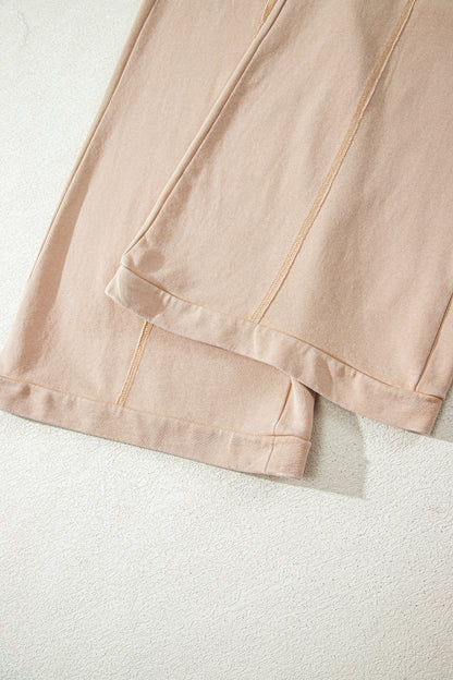 Sand washed cotton wide leg pants with drawstring waist, oversized patch pockets, and relaxed fit.