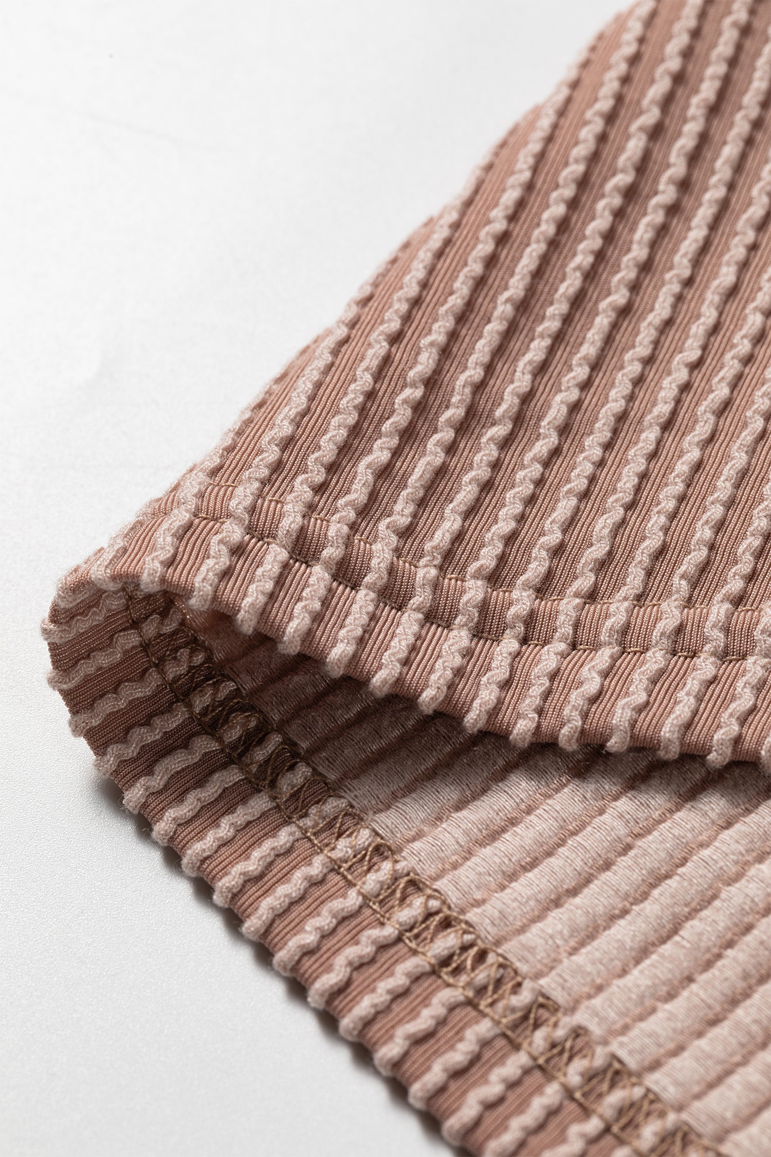 Women's ribbed color block hooded top in ivory, coral, and taupe with a V-neckline, drawstrings, long sleeves, and relaxed fit.