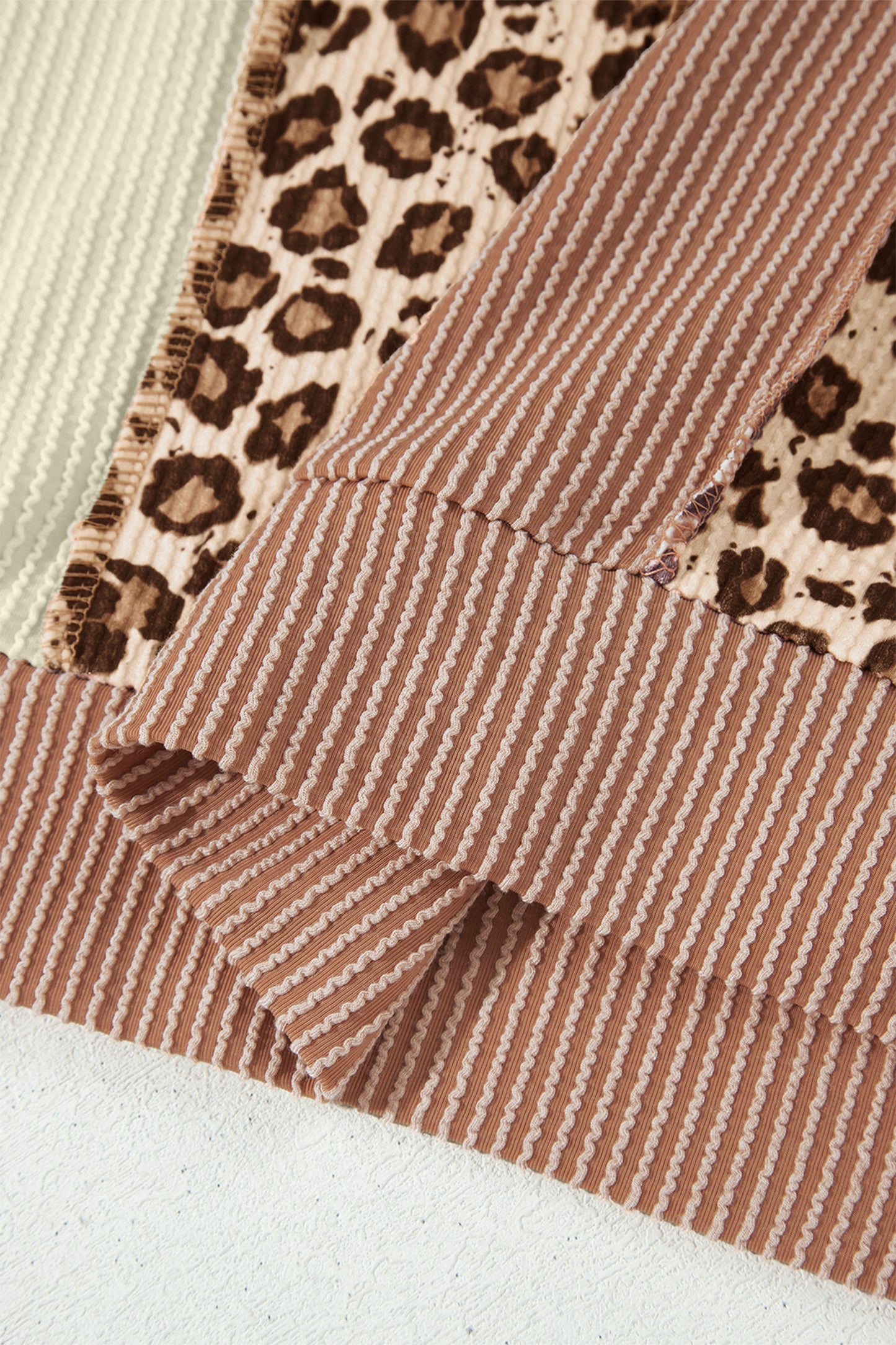 mocha brown leopard colorblock ribbed knit top with a round neckline, dropped shoulders, relaxed fit, and long sleeves.