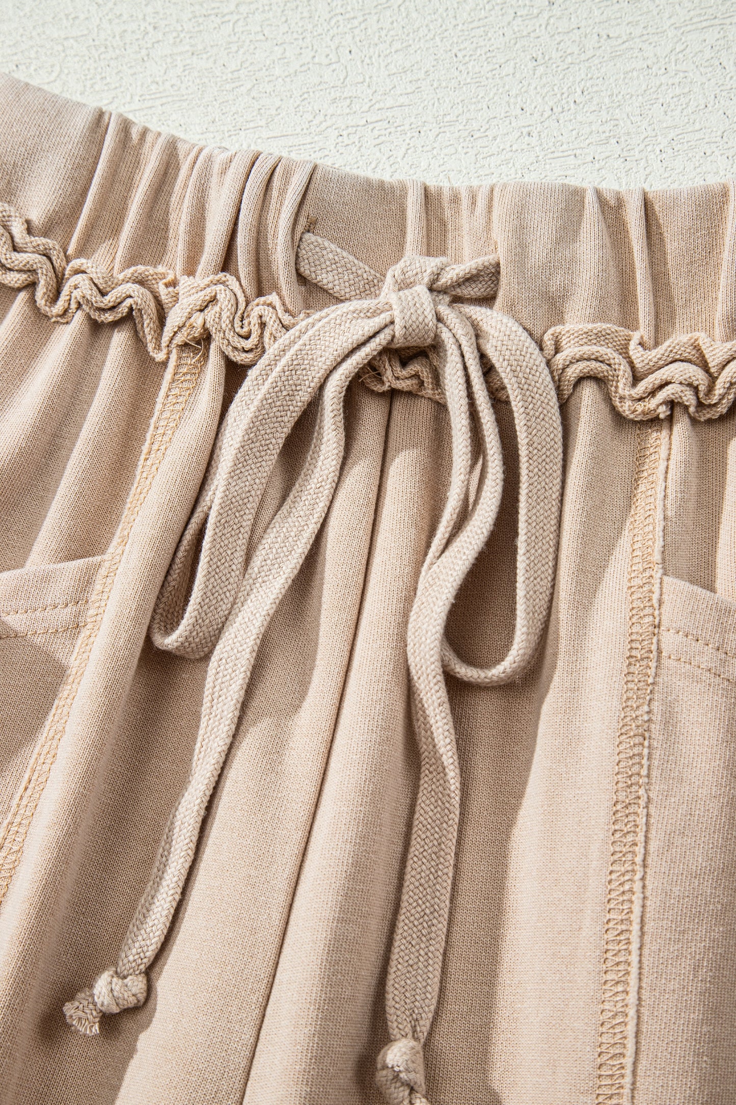 Sand washed cotton wide leg pants with drawstring waist, oversized patch pockets, and relaxed fit.