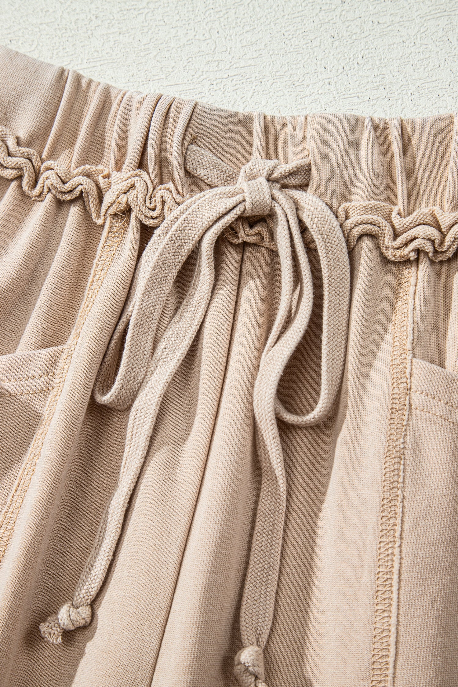 Sand washed cotton wide leg pants with drawstring waist, oversized patch pockets, and relaxed fit.