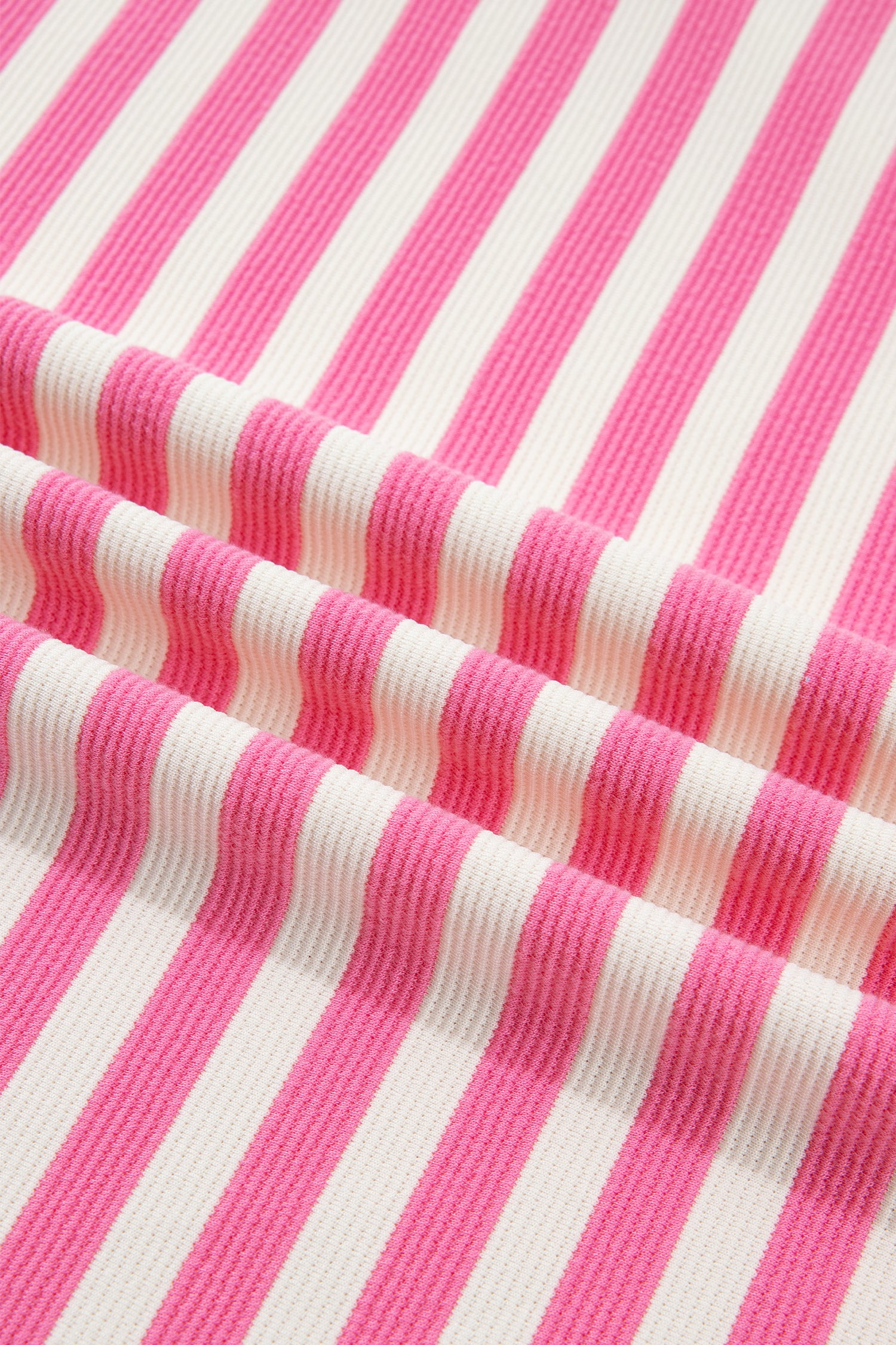 Pink and white textured striped knit short sleeve top with blue contrast ribbed neckline and sleeve cuffs, relaxed fit, and crew neckline.