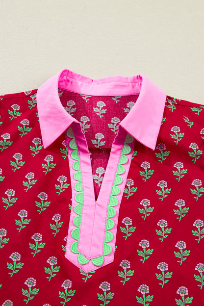 Red floral mini dress with pink collared neckline, mint scalloped trim, short puff sleeves, and a ruffled drop-waist hem