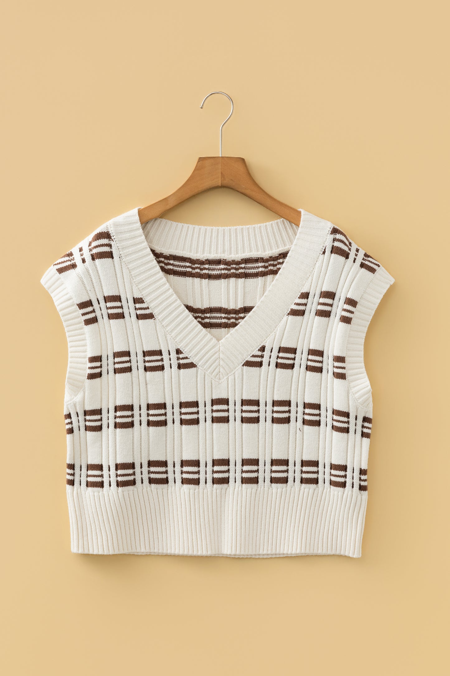 Oatmeal knit sweater vest with brown striped pattern, V-neckline, sleeveless design, and ribbed trim.