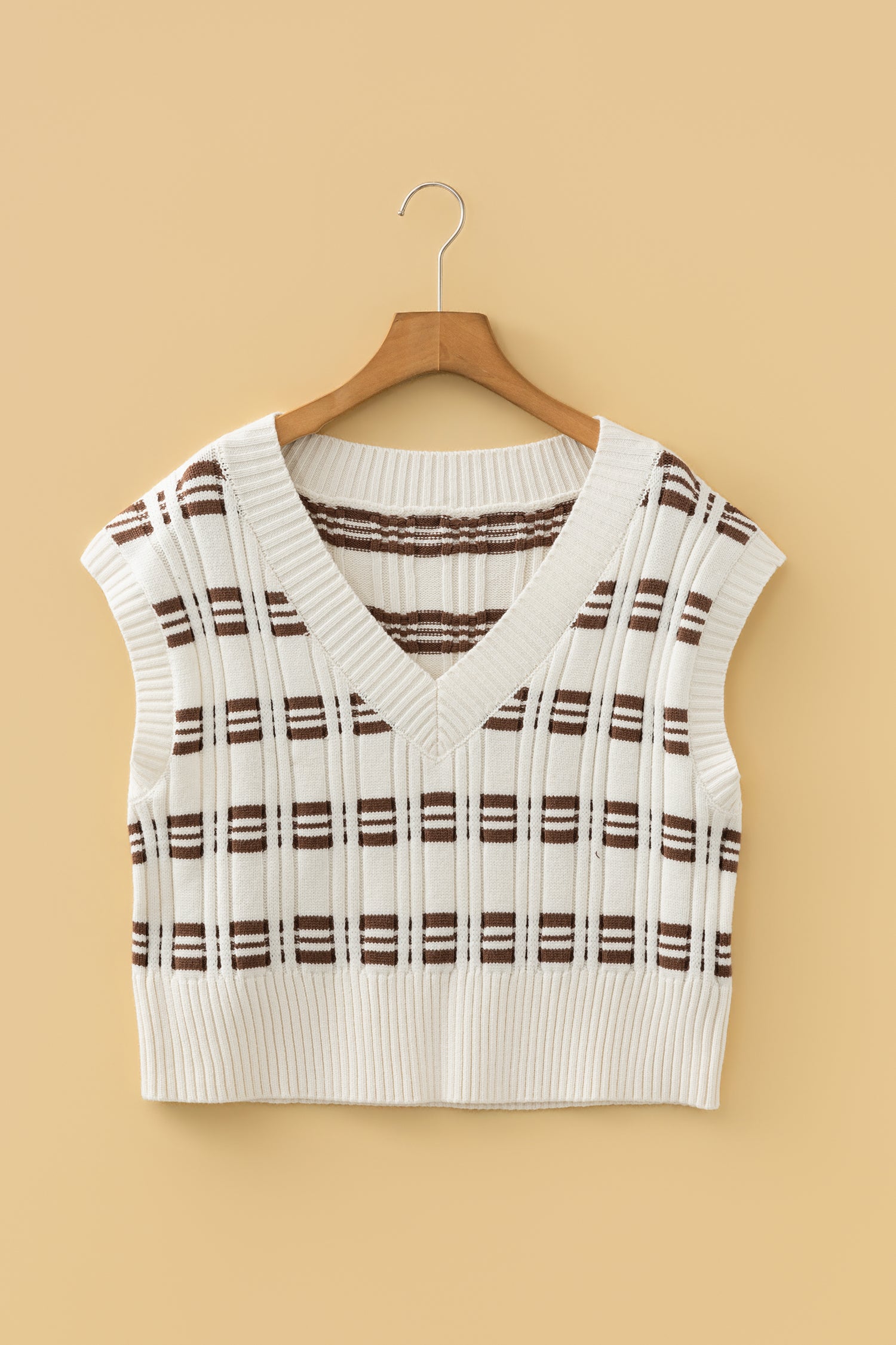 Oatmeal knit sweater vest with brown striped pattern, V-neckline, sleeveless design, and ribbed trim.