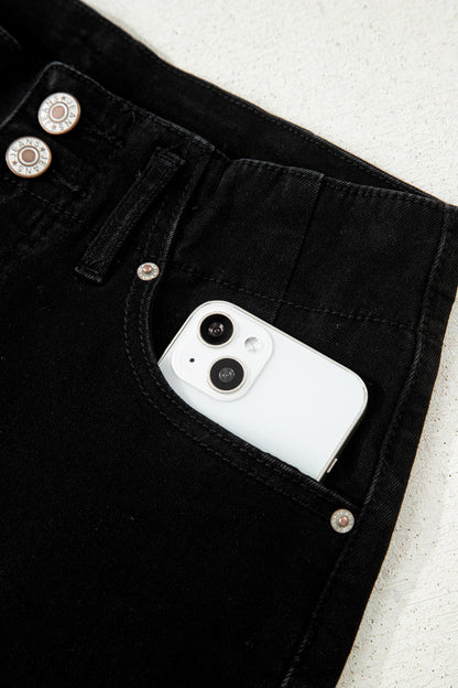 Black high rise wide leg jeans with double-button waistband, front pockets and cropped hem.