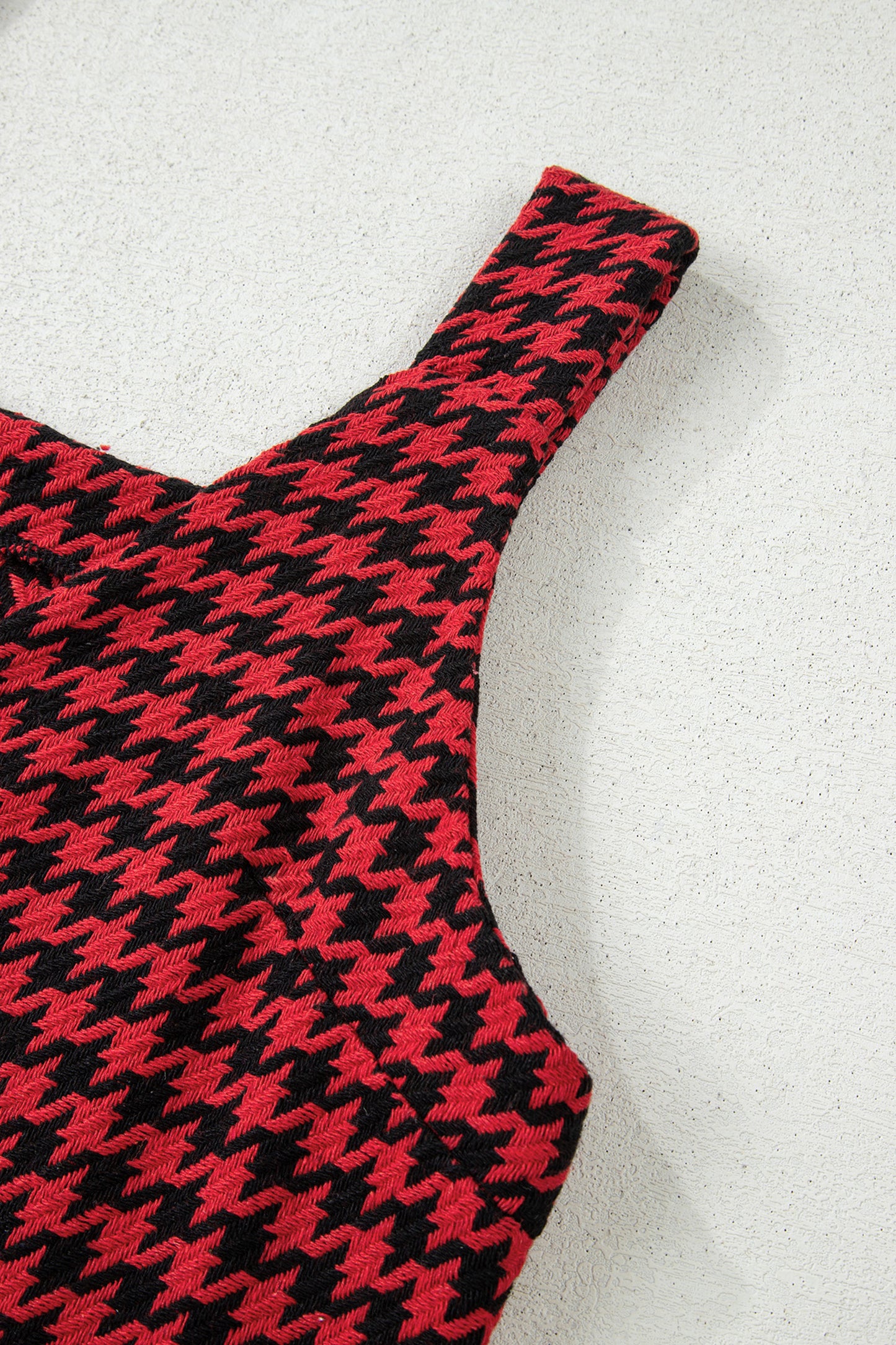 Red textured houndstooth jacquard sleeveless mini dress with V-neckline and A-line silhouette.