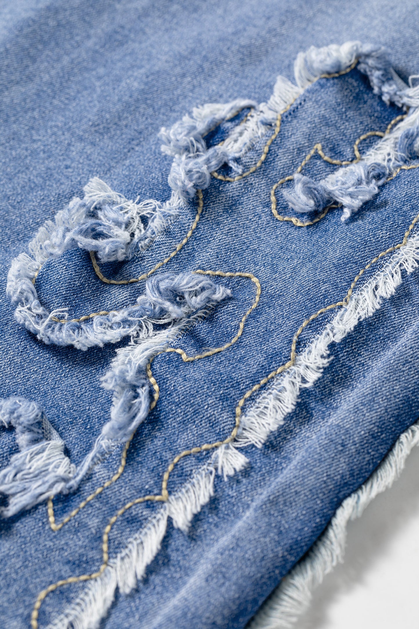Light Wash Blue high rise Western flare jeans with embroidered lower-leg detailing and full-length wide leg silhouette.