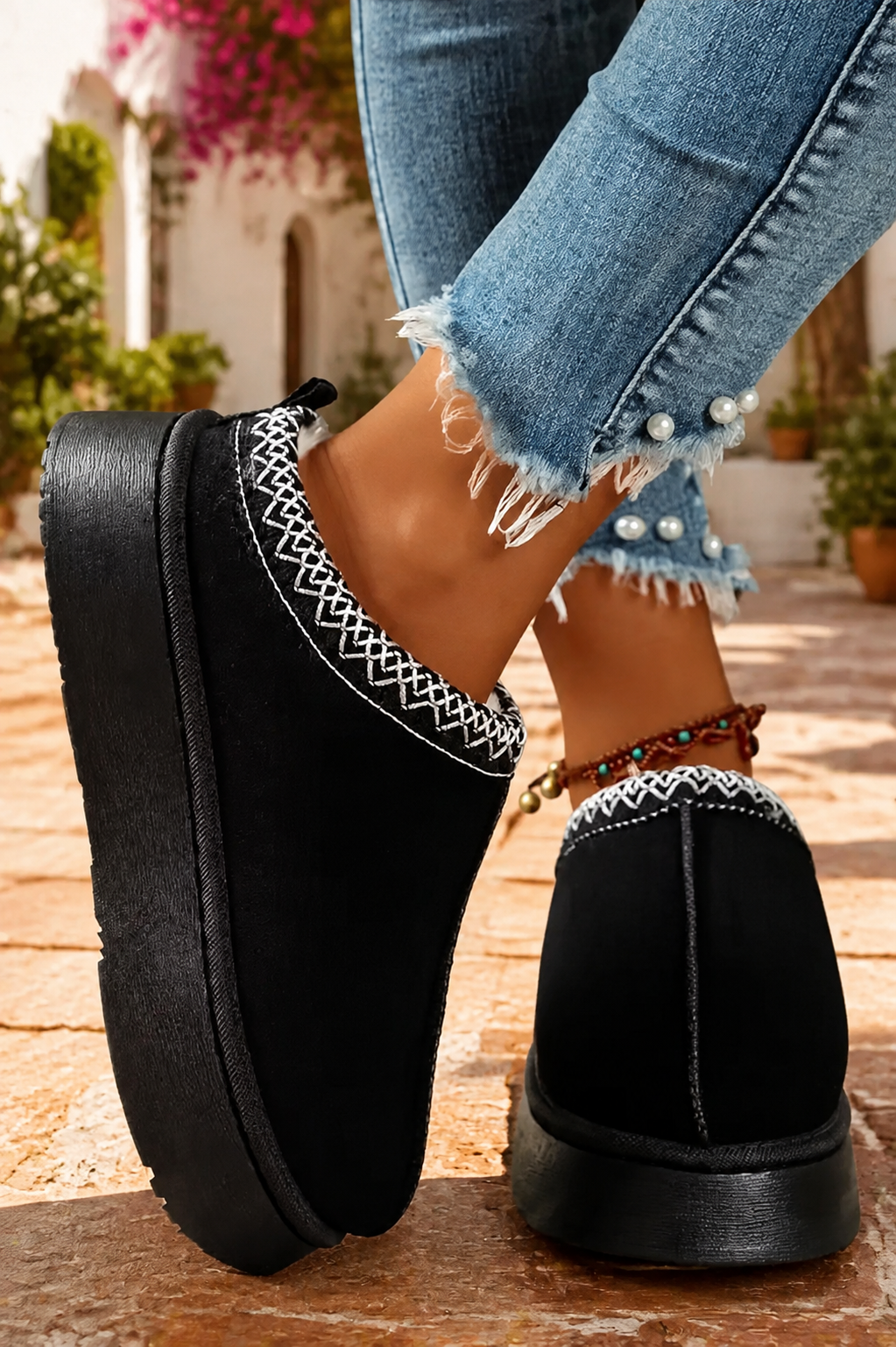 Black faux-suede platform slippers with cream plush lining, round toes, and contrasting white stitched collar trim