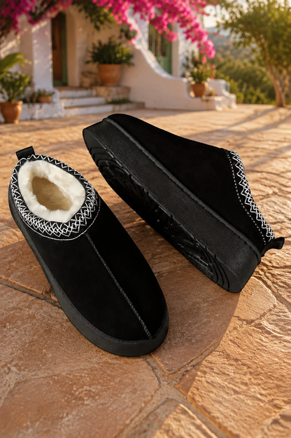 Black faux-suede platform slippers with cream plush lining, round toes, and contrasting white stitched collar trim