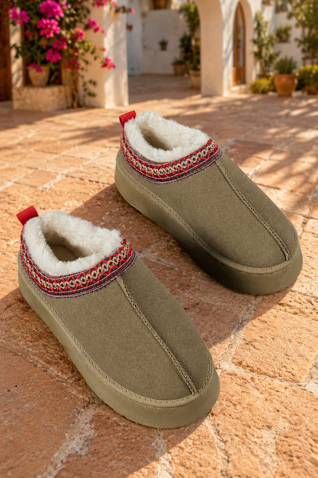 Olive green faux-suede platform slippers with plush lining, round toes, and decorative red stitched collar trim