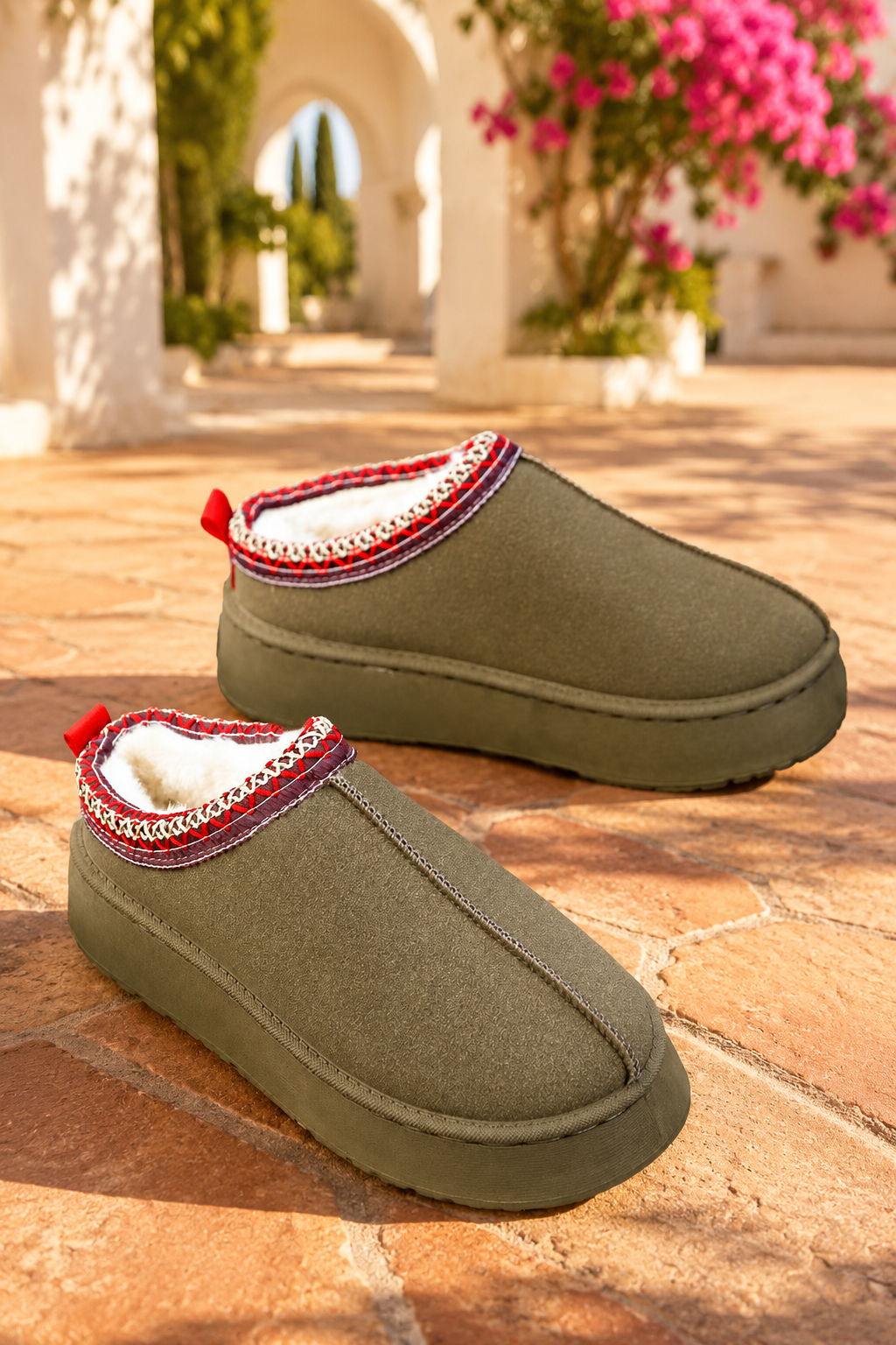 Olive green faux-suede platform slippers with plush lining, round toes, and decorative red stitched collar trim