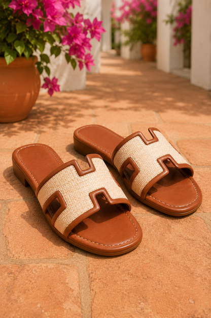Women's Chestnut woven H-cut flat slide sandals with raffia-inspired texture, faux leather trim, open toe, and comfortable slip-on design.