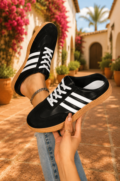 Women's Midnight Noir retro lace-up casual sneakers featuring a black faux leather upper, suede-look overlays, white side stripes, white laces, and a gum rubber sole.