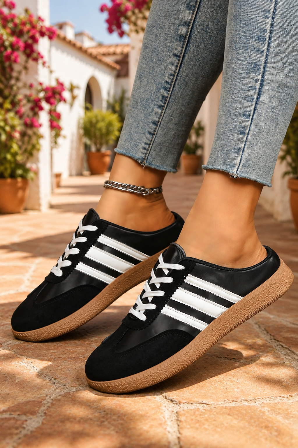 Women's Midnight Noir retro lace-up casual sneakers featuring a black faux leather upper, suede-look overlays, white side stripes, white laces, and a gum rubber sole.