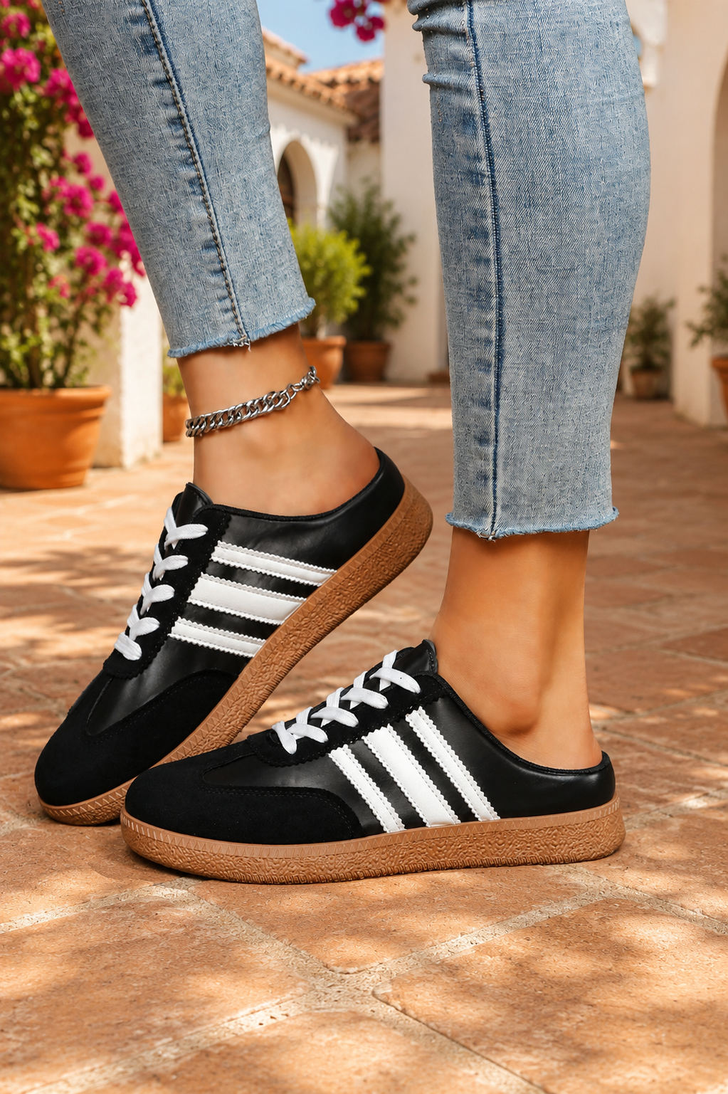 Women's Midnight Noir retro lace-up casual sneakers featuring a black faux leather upper, suede-look overlays, white side stripes, white laces, and a gum rubber sole.