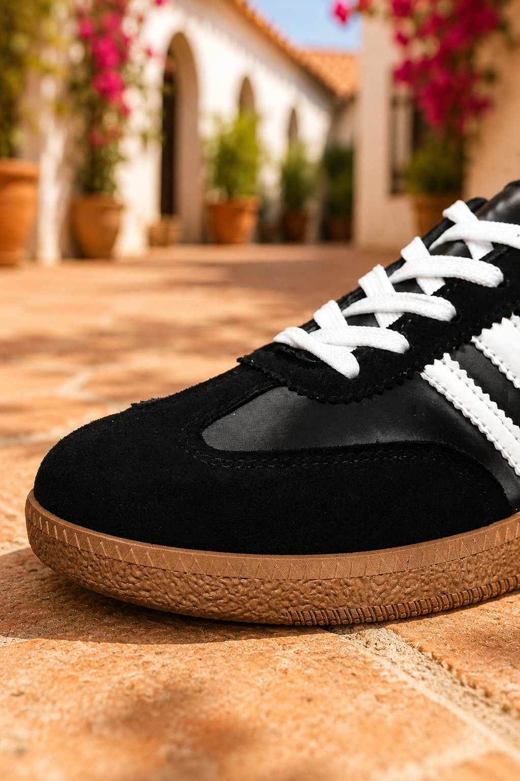 Women's Midnight Noir retro lace-up casual sneakers featuring a black faux leather upper, suede-look overlays, white side stripes, white laces, and a gum rubber sole.