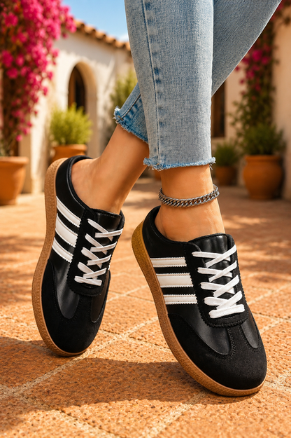 Women's Midnight Noir retro lace-up casual sneakers featuring a black faux leather upper, suede-look overlays, white side stripes, white laces, and a gum rubber sole.
