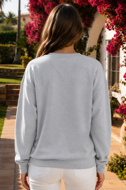 Light gray PRAY patchwork crewneck sweatshirt with floral, pink striped, plaid and black appliqué lettering.