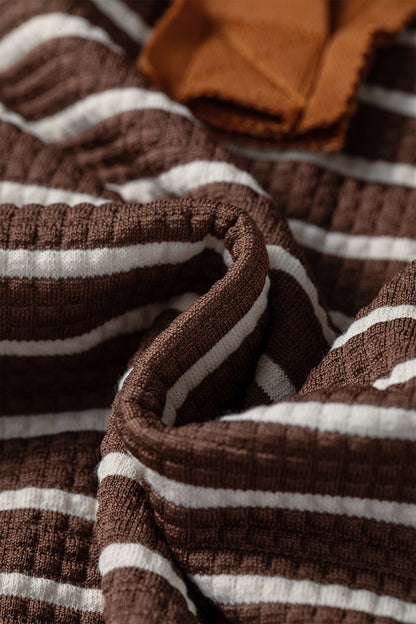 Cocoa Caramel and ivory striped colorblock pullover with a collared V-neckline, dropped shoulders, and long paneled sleeves.