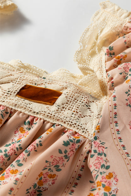 Blush floral babydoll mini dress with floral stripe print, cream lace-trimmed square neckline, brown velvet bow, and long sleeves.