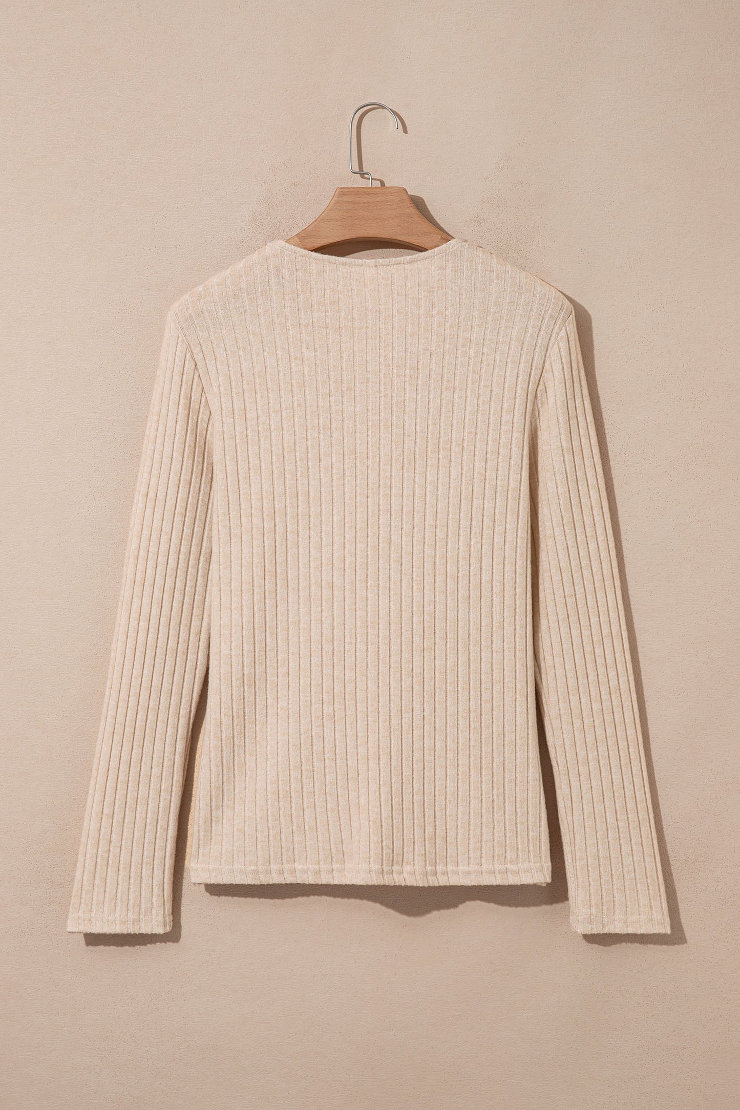 Oatmeal women's long sleeve top with fine vertical ribbed texture, a softly draped cowl neckline, and a flattering fitted silhouette.