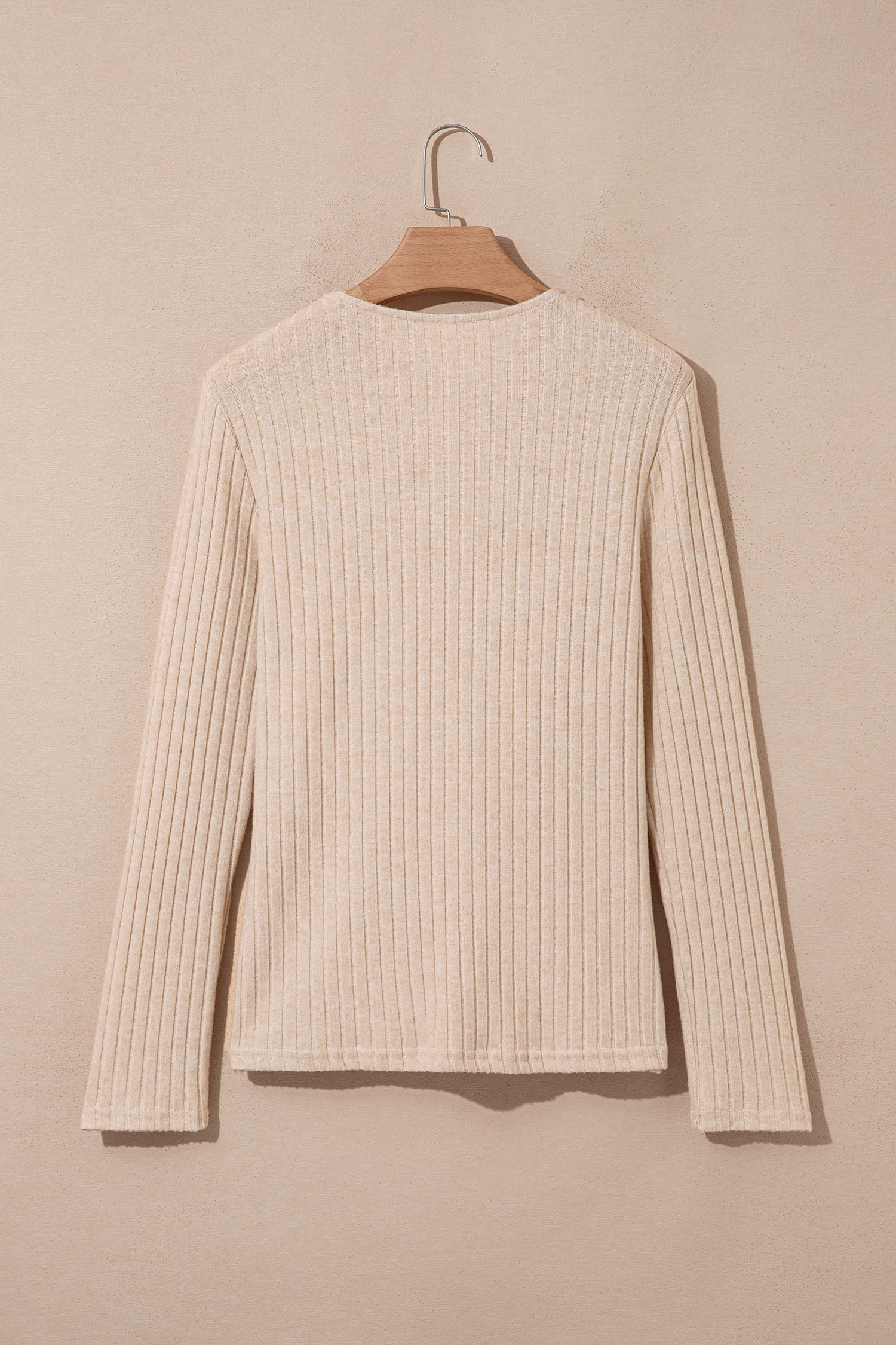 Oatmeal women's long sleeve top with fine vertical ribbed texture, a softly draped cowl neckline, and a flattering fitted silhouette.