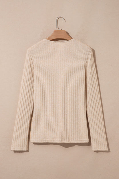 Oatmeal women's long sleeve top with fine vertical ribbed texture, a softly draped cowl neckline, and a flattering fitted silhouette.