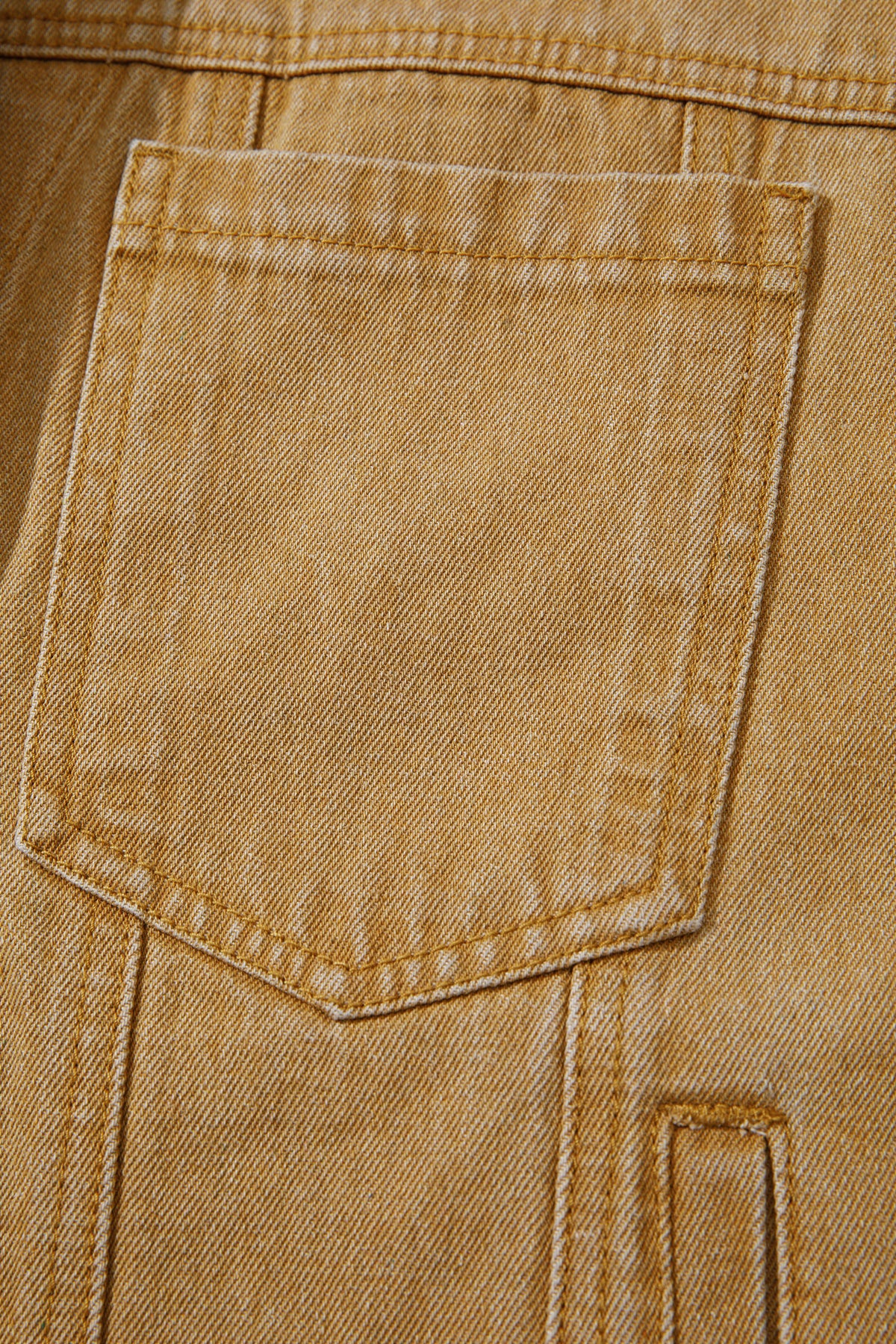 Tan women's denim jacket with metal button front, collared neckline, long sleeves, patch pockets, and relaxed fit.