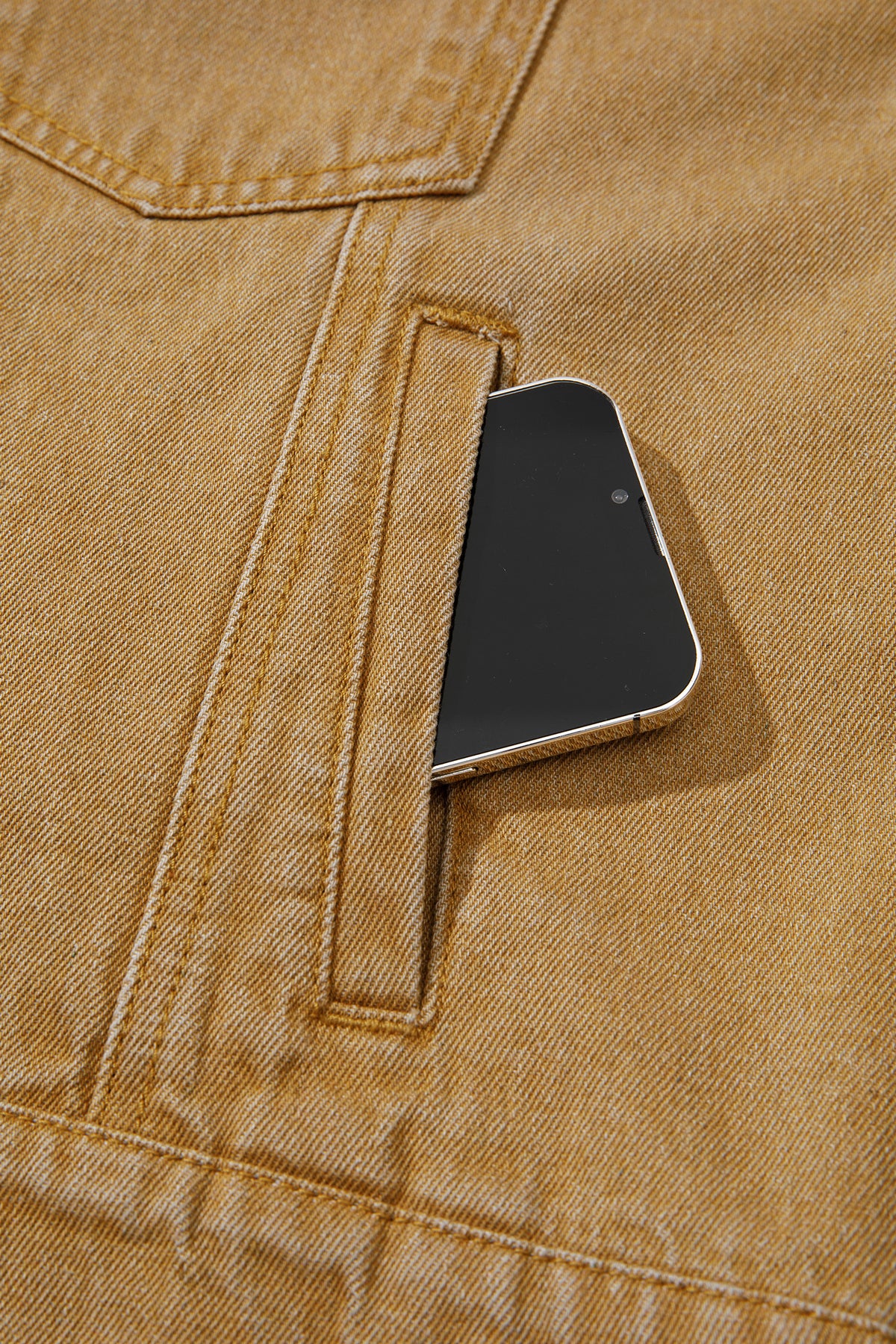 Tan women's denim jacket with metal button front, collared neckline, long sleeves, patch pockets, and relaxed fit.